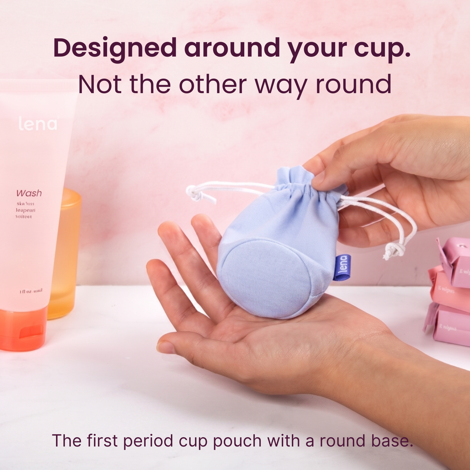 Period cup pouch with round base held in hand, with text 'Designed around your cup. Not the other way round' and 'The first period cup pouch with a round base.