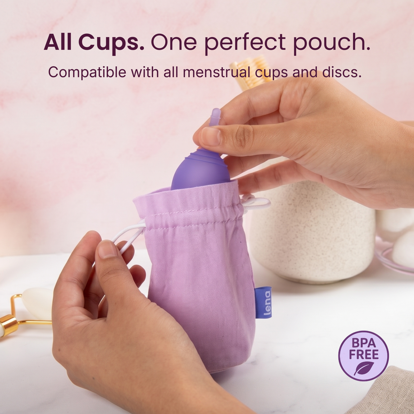 Purple pouch with a menstrual cup being placed inside, on a light pink background.