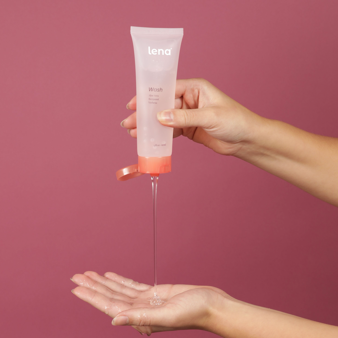 Hand holding and squeezing Lena Wash tube