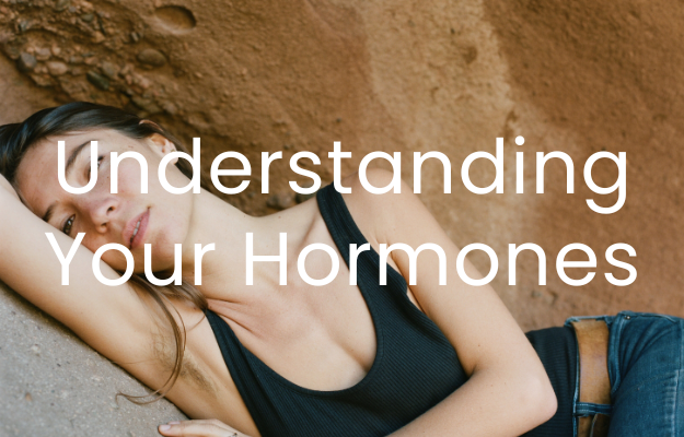 A woman lies sideways resting on her arm on a rock, with text "Understanding Your Hormones" overlaid