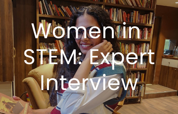 Image of a woman sat in a library, she is touching her hair. The text "Women in STEM: Expert Interview" is overlaid