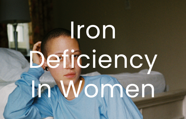 A woman looks at the camera in a blue jumper. the text "Iron Deficiency In Women" Is overlaid 