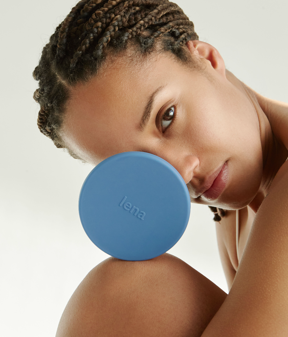 Person holding a blue lena cleaning container close to their face