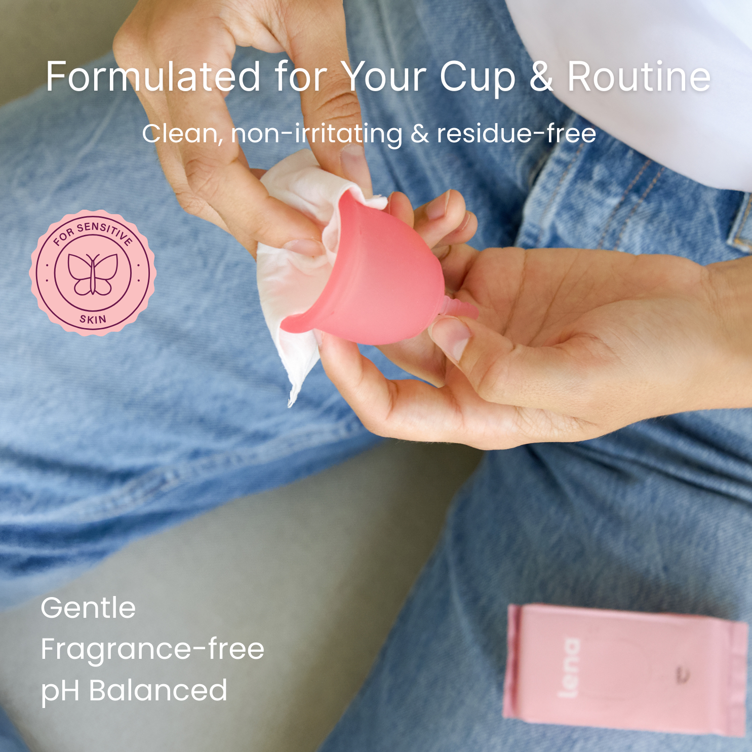Pink Menstrual Cup being wiped by a Lena Wipe