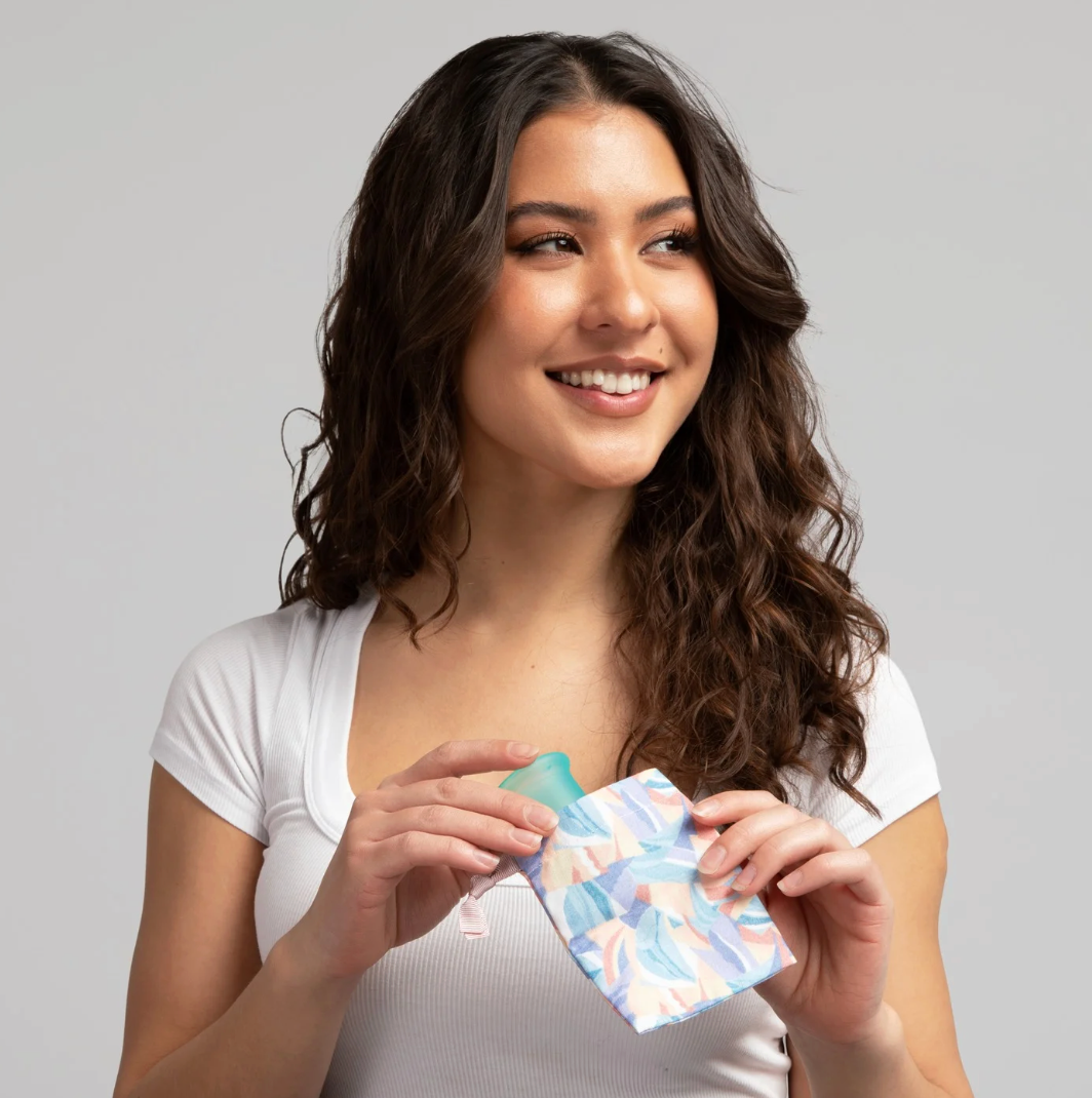 Woman holding a colorful product against a gray background